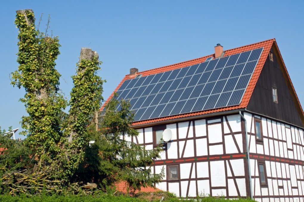 Old frame house with solar cells on the roof